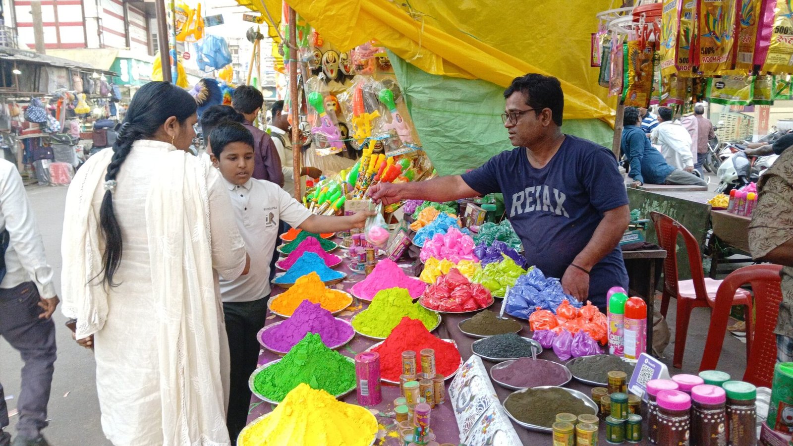 Markets decorated for Holi, poles and flags set up