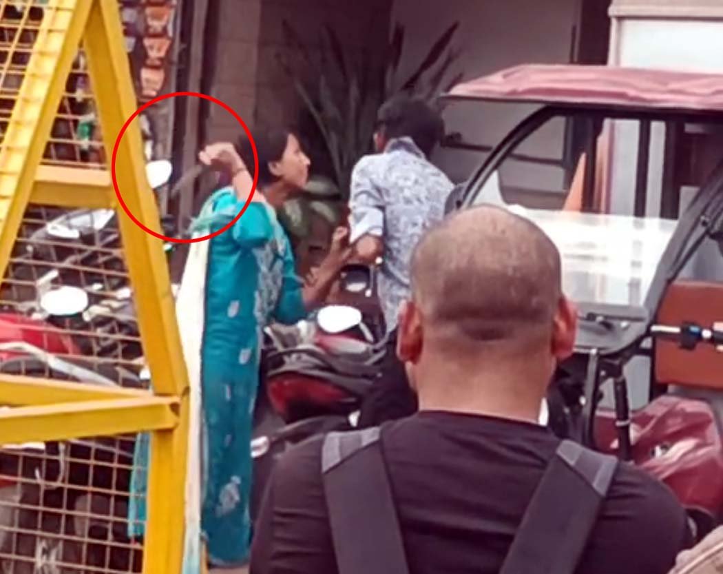 Horror: Video of a woman threatening a young man with a knife outside a railway station goes viral!