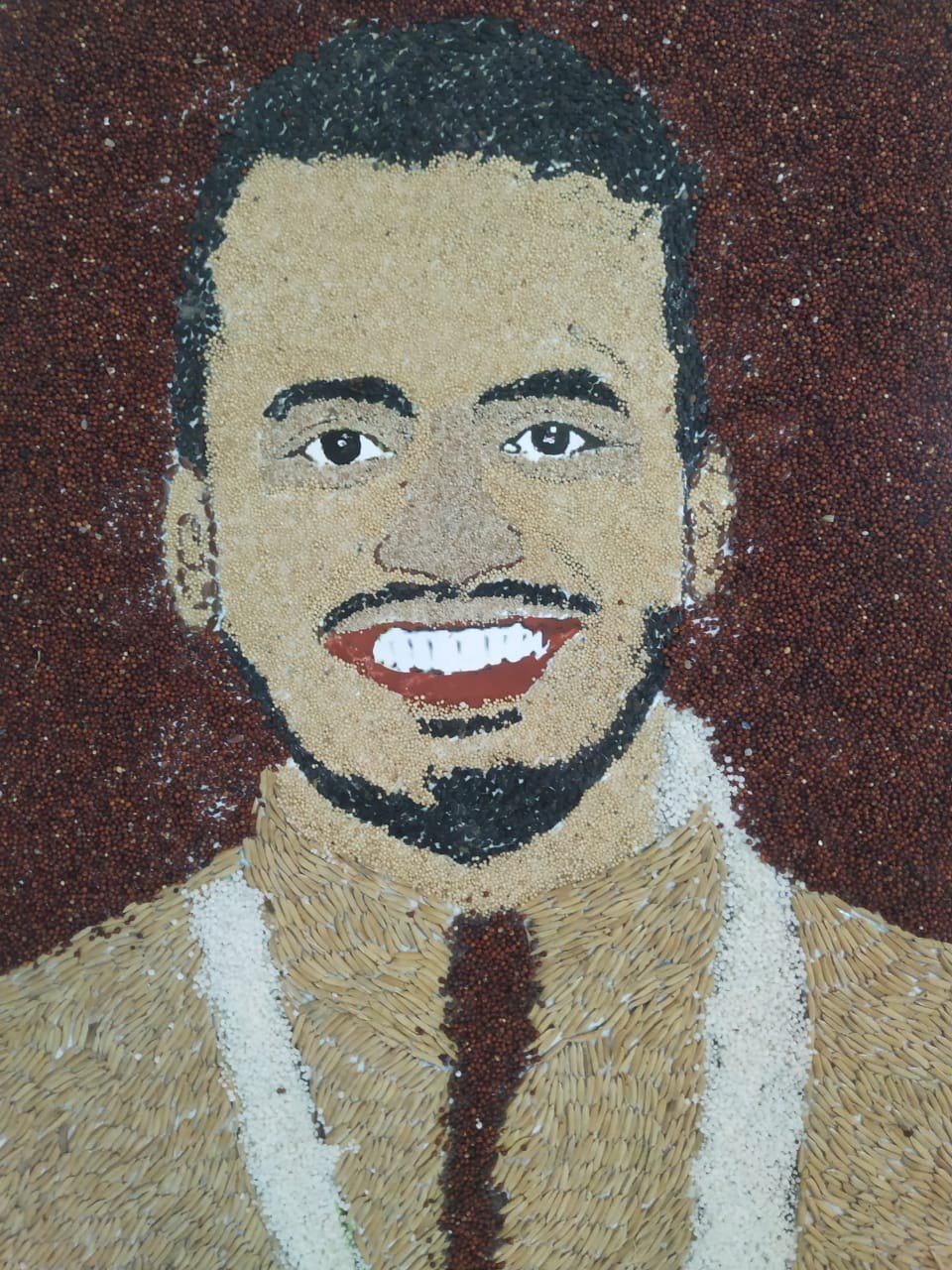 Field artists salute the magician of the game, Vivek Sagar's face carved from grains of grain.