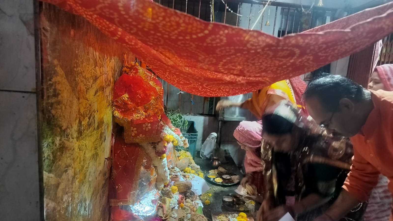 A queue of devotees gathered at the court of Mother Sheetla, the goddess of health; stoves were not lit in homes as per tradition.